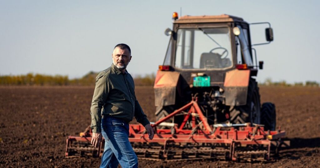 Proud farmer walking in a field