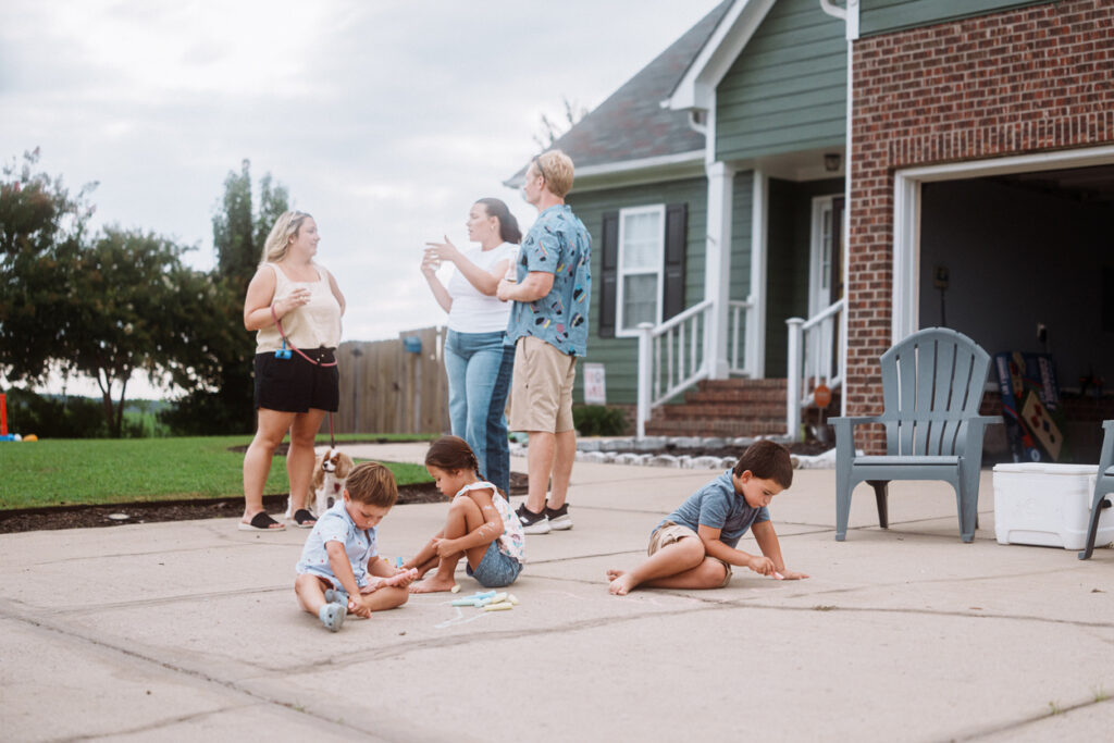 Kids Playing With Chalk During Outdoor Neighbor Gathering
